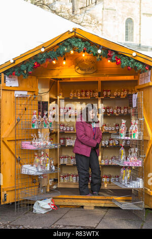 Little Village Sweet Shop - Market stall holder selling sweets at Winchester Christmas Market, Hampshire, UK in December Stock Photo