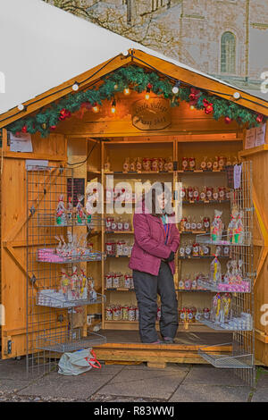 Little Village Sweet Shop - Market stall holder selling sweets at Winchester Christmas Market, Hampshire, UK in December - hdr effect Stock Photo