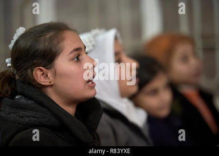 Girls participate in a class to catch up with their school work in war-torn Mosul, Iraq, where many didn't attend school for three years under ISIS. Stock Photo