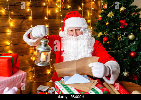 Santa Claus is preparing for Christmas, reading children's letters. Mail of Santa Claus. Christmas decoration. Stock Photo