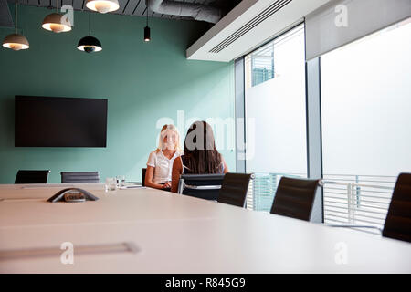Businesswoman Interviewing Female Candidate At Graduate Recruitment Assessment Day In Office Stock Photo