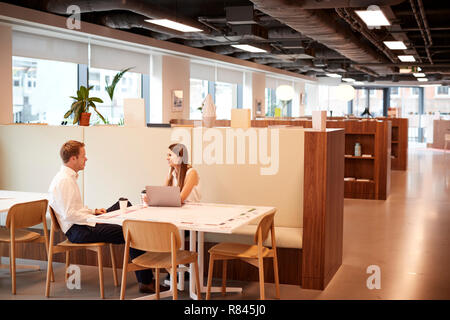 Young Businessman Having Informal Interview In Cafeteria Area At Graduate Recruitment Assessment Day Stock Photo
