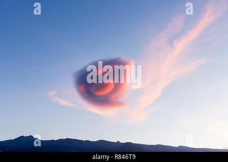 Tenerife, Canary Islands, Spain, 13th December 2018. Unusual lenticular cloud formation mimicing the classic UFO spaceship shape appears over Tenerife Stock Photo