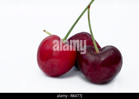 Three Red Stone Cherries on white background Stock Photo