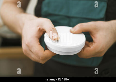 Man testing smoke detector before use. Stock Photo