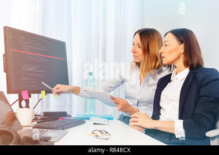 Side view portrait of two businesswomen working with computer in the office Stock Photo