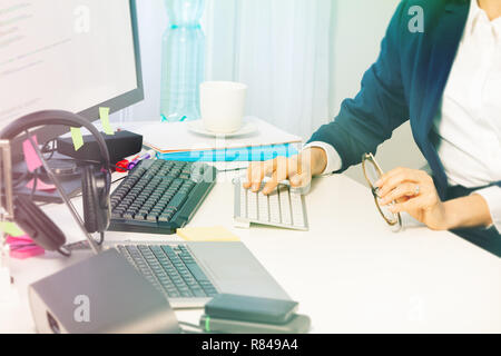 Woman's hands typing on the computer keyboard Stock Photo