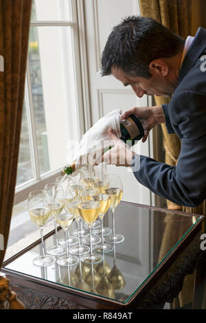 Ireland, Dublin, The Merrion Hotel, waiter pouring champagne Stock Photo