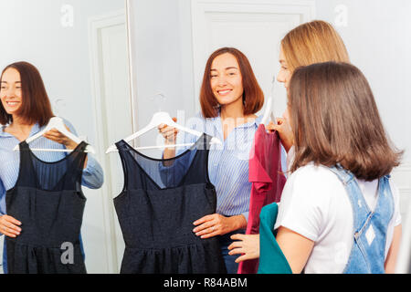 Mother and teenage daughters in evening wear store Stock Photo