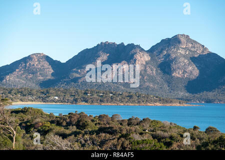 Hazard mountain range, Freycinet National Park, Tasmania taken from Coles Bay on a sunny day with blue sky Stock Photo