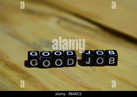 Good job message written on wooden blocks. education and motivation concepts. Cross processed image on Wooden Background Stock Photo