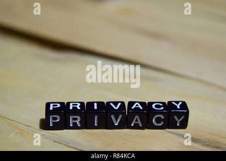 Privacy message written on wooden blocks. education and motivation concepts. Cross processed image on Wooden Background Stock Photo
