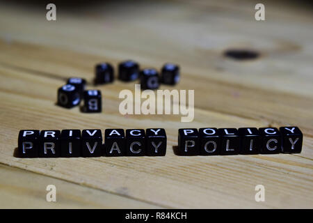 Privay policy message written on wooden blocks. education and motivation concepts. Cross processed image on Wooden Background Stock Photo
