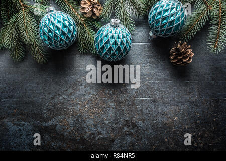 Top of view christmas balls fir tree pine cones on free concrete background. Stock Photo