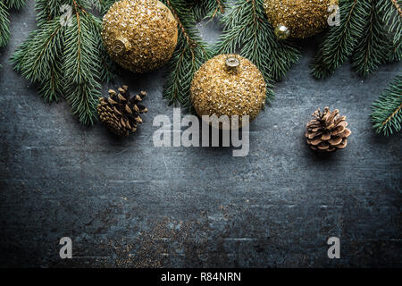 Top of view christmas balls fir tree pine cones on free concrete background. Stock Photo