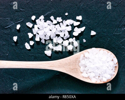 coarse sea salt on dark background close up. Copy space. Flat lay or top view Stock Photo
