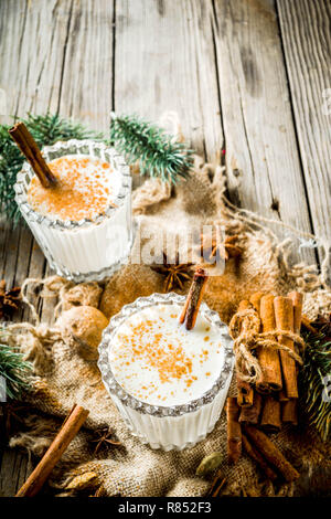 https://l450v.alamy.com/450v/r852f3/classic-christmas-drink-eggnog-chilean-cola-de-mono-monkey-tail-cocktail-or-puerto-rican-coquito-eggnog-on-old-wooden-background-with-pine-tree-r852f3.jpg