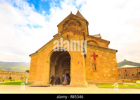 Mtskheta, Georgia - April 28, 2017: Priests entering Svetitskhoveli Cathedral located in the historical town of Mtskheta, Georgia Stock Photo