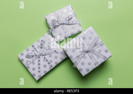 Gift boxes in peas with silver bows at pink background, top view, border design with copy space, template for text Stock Photo