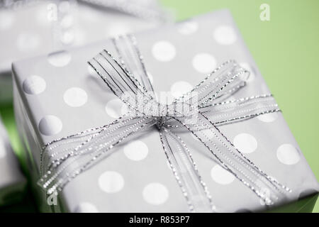Gift boxes in peas with silver bows at pink background, top view, border design with copy space, template for text Stock Photo