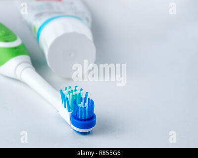 Electric toothbrush on white background. Head electrical toothbrush close up. Electric toothbrush and toothpaste. Copy space Stock Photo