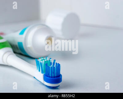 Electric toothbrush on white background. Head electrical toothbrush close up. Electric toothbrush and toothpaste. Copy space Stock Photo