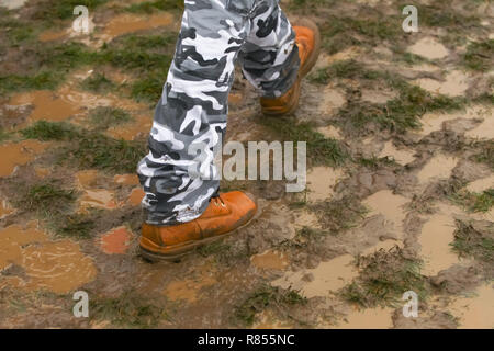 A man walking in the mud. Stock Photo