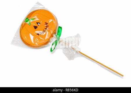 Homemade gingerbread on a stick in the form of a pumpkin in a bag isolated on white. Stock Photo