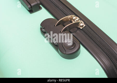 Closeup of a security padlock with three numbers on green suitcase Stock Photo