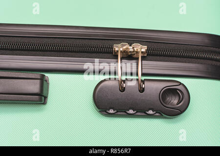 Closeup of a security padlock with three numbers on green suitcase Stock Photo