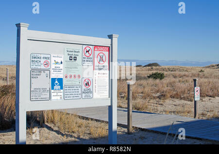 Signs with rules and regulations at entrance to Scusset Beach, Cape Cod in Sagamore, Bourne, Massachusetts USA Stock Photo