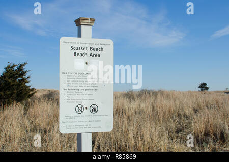 Scusset Beach in Sagamore, Bourne Cape Cod, Massachusetts, USA visitor guidelines sign and rules posted by sand dunes with grass Stock Photo