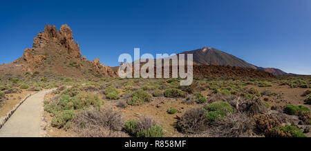 Panoramic view of the lava fields of Las Canadas caldera and rock formations of Roques de Garcia. In the background is the Teide volcano. Tenerife. Ca Stock Photo