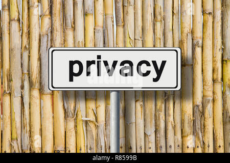 Privacy written on road sign against a bamboo fence - concept image Stock Photo