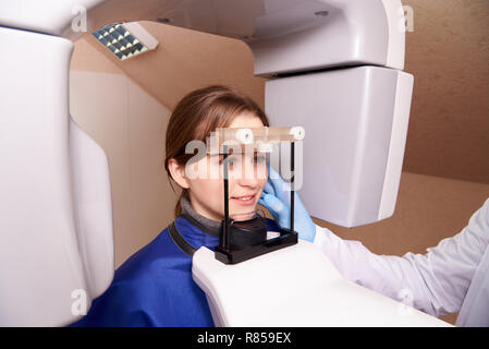 Patient standing in x-ray machine. Panoramic radiography.Computed tomography in dentistry. Stock Photo