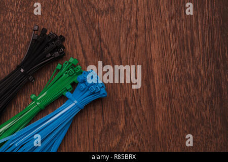 heaps of cable ties on wooden background Stock Photo