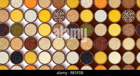 Cereals, grains and flakes in wooden bowls. Seamless pattern. Top view Stock Photo