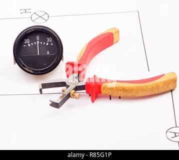 Ammeter and insulation stripper carbon brush on a background of the electric scheme Stock Photo