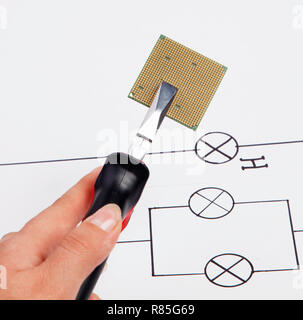 Modern central computer processors CPU clamped in the pliers Stock Photo
