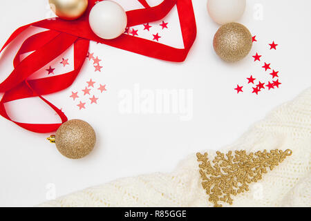 Christmas composition. Christmas wreath, golden and red decorations on white background. Flat lay, top view, copy space Stock Photo