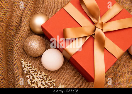 Christmas background, celebration, New Year's eve party, sale, presents concept. Beautiful gift box with decorations, flat lay Stock Photo