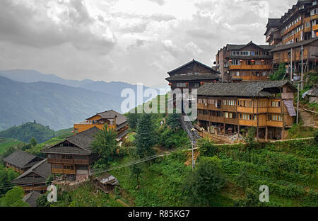 Chinese village in the beautiful terraced rice fields in Longsheng. Tian Tou Zhai village in longji rice terrace in guangxi province of China. Stock Photo