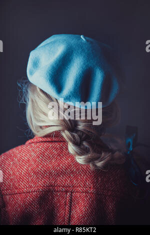 Historical woman in winter coat holding a book Stock Photo