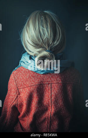 Historical woman in winter coat holding a book Stock Photo