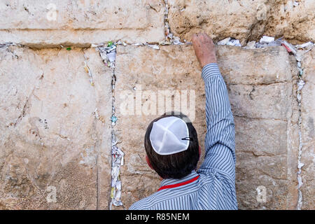 Jerusalem Israel, leave the letter with a prayer. Tourist Jew puts a letter with a request to God in the gap in the wailing wall Stock Photo