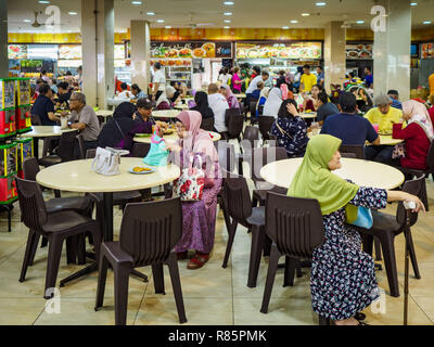 Singapore, Singapore. 13th Dec, 2018. The ''hawker stalls'' in the Joo Chiat complex in the Geylang neighborhood. Joo Chiat is a multi-tower high rise residential estate. Hawker stalls used to be street food stalls, but the government of Singapore has moved them into permanent food courts. There are hawker food stalls and retail businesses on the ground floor and residences on the upper levels. The Geylang area of Singapore, between the Central Business District and Changi Airport, was originally coconut plantations and Malay villages. During Singapore's boom the coconut plantations and Stock Photo