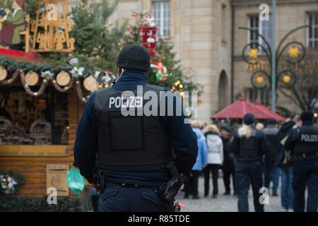 Dresden, Germany. 13th Dec, 2018. Policemen walk across Dresden's Striezelmarkt. After the attack in Dresden's twin city Strasbourg, the authorities consider the protection at Saxony's Christmas markets to be sufficient. Credit: Sebastian Kahnert/dpa-Zentralbild/dpa/Alamy Live News Stock Photo