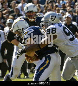 Oakland, California, USA. 11th Sep, 2006. San Diego Chargers guard Kris  Dielman (68) and Oakland Raiders defensive end Tommy Kelly (93) have words  after play on Monday, September 11, 2006, in Oakland