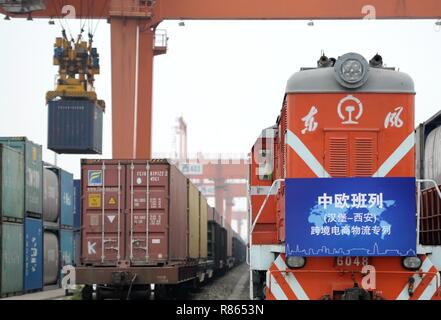 (181214) -- BEIJING, Dec. 14, 2018 (Xinhua) -- Photo taken on May 21, 2018 shows a cross-border e-commerce freight train from Hamburg of Germany arriving in Xi'an, northwest China's Shaanxi Province. China-Europe freight trains made 5,611 trips in the first 11 months of 2018, surging 72 percent compared with the same period last year, according to a meeting held in southwest China's Sichuan Province. In 2017, more than 3,000 trips were made via the China-Europe freight trains between cities on the two continents. The number is expected to reach 6,000 in 2018, according to the meeting held Stock Photo