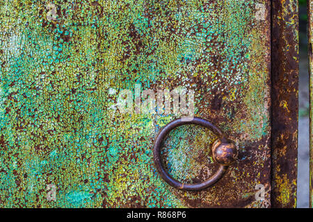 round iron brown door knob on the green shabby wall Stock Photo